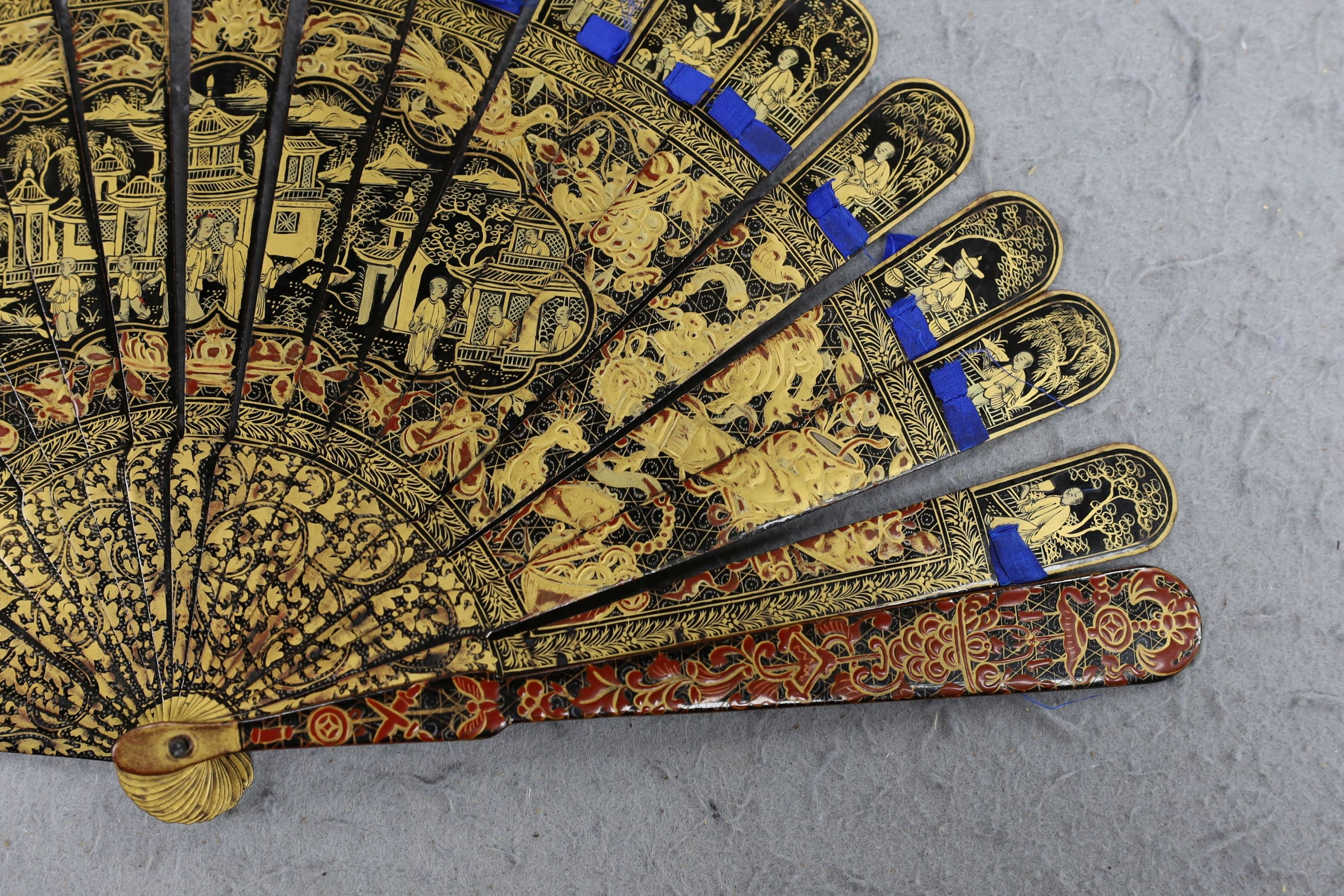 A Chinese gilt-decorated lacquer fan in a brocade covered case, 19th century